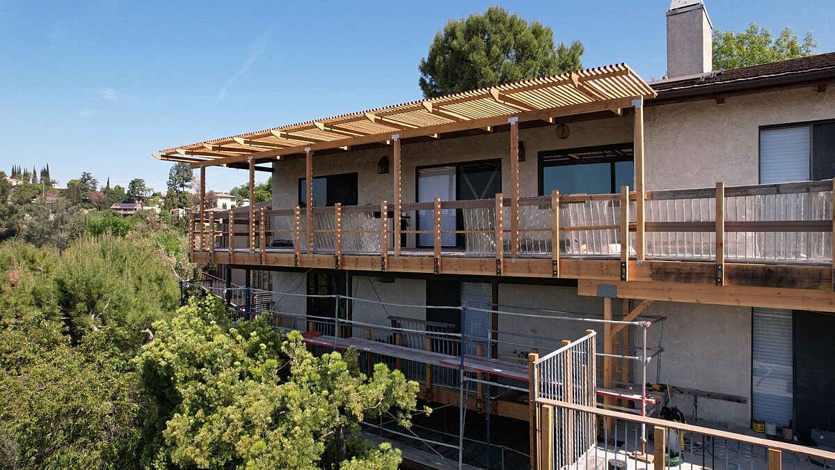 Modern wooden deck on multi-story building.