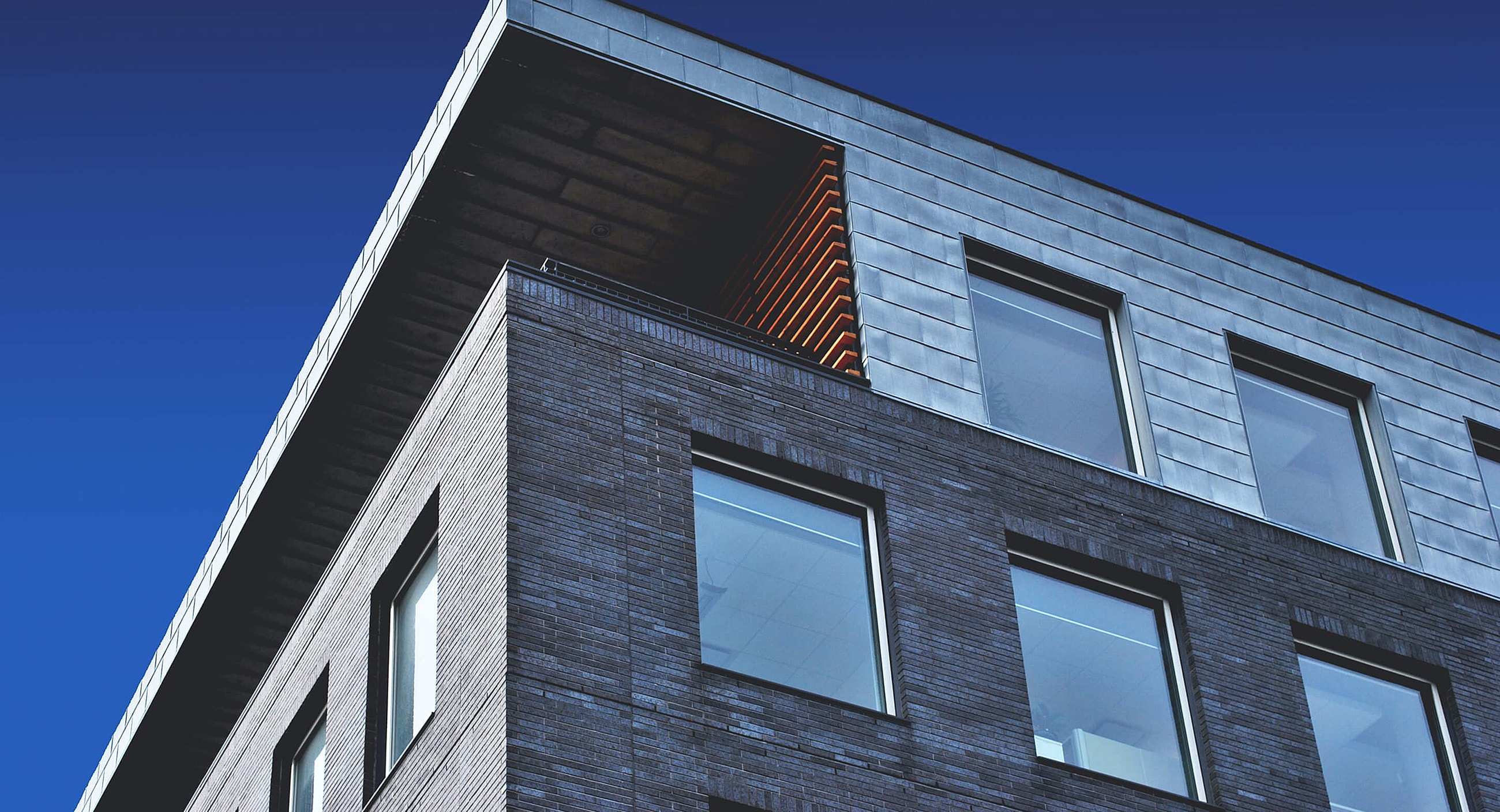Modern building corner against blue sky.