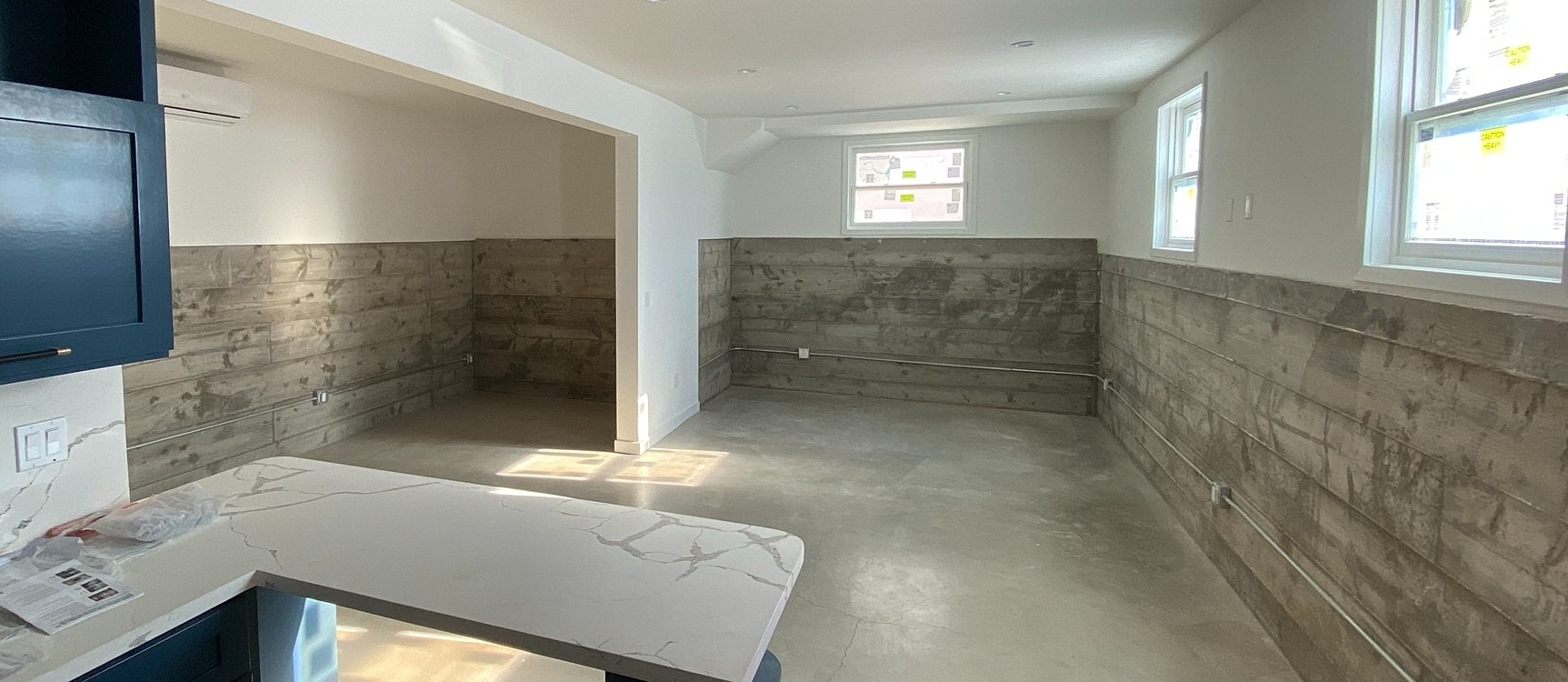Empty room with concrete floor and wooden walls